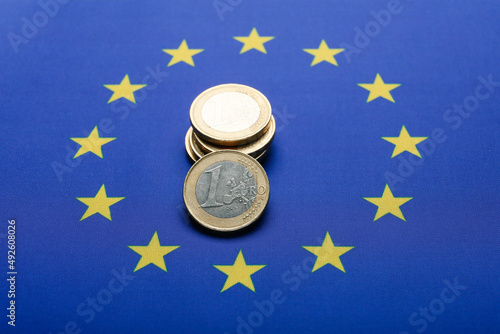 Coins on flag of European Union, closeup photo