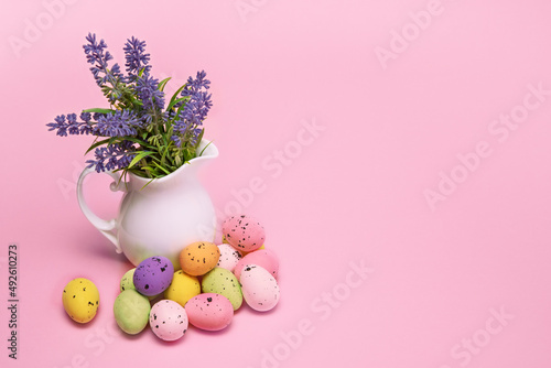 Easter colorful eggs lie next to a bouquet of flowers in a vase, Easter card with space for text photo