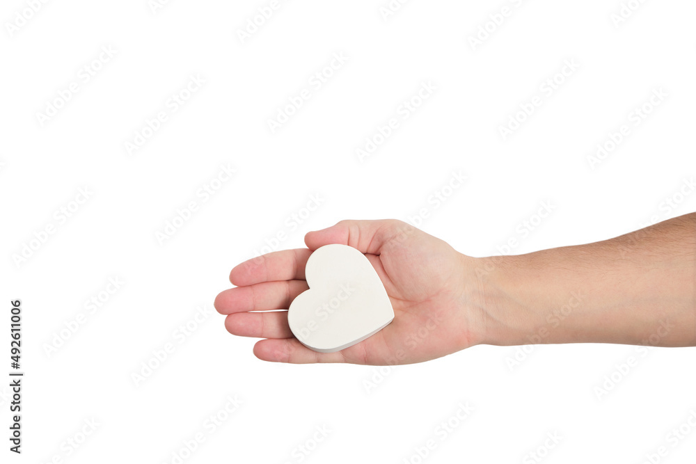 White heart in a mans hand on a white background. White heart in a mans hand on a white background.