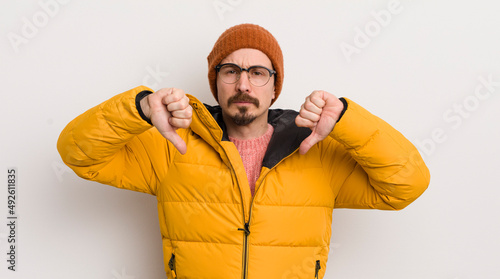 young handsome man with a coat against white wall photo