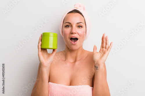 pretty blonde woman with a hair porduct bottle photo