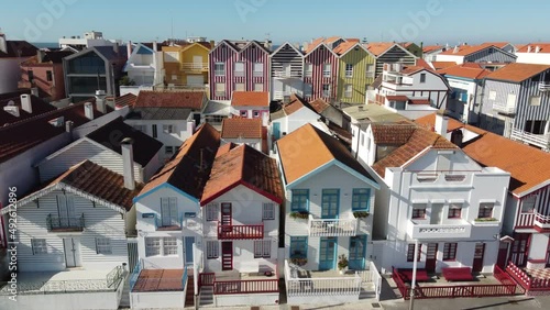 Aerial shot of coloured houses in Costa Nova do Prado in Portugal, Flying sideways in front of the houses from left to the right. Europe, Aveiro photo