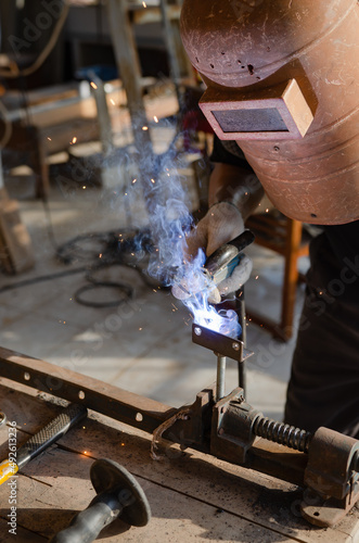 young man doing hobbies welding steel in his workshop Soft focus