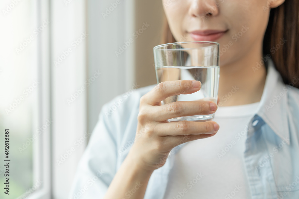 Clean freshwater concept. Woman drink mineral water in the morning for good health. Clean freshwater concept. Woman drink mineral water in the morning for good health.