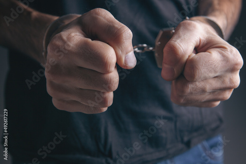 Фотография men handcuffed in criminal concept