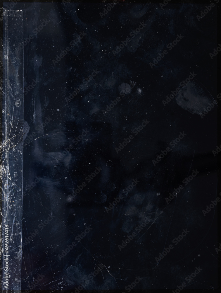 Fototapeta premium detail macro photo of dirty tablet display device surface with smudgy fingerprints, dust, scratches and broken glass. sticker remain on glass.