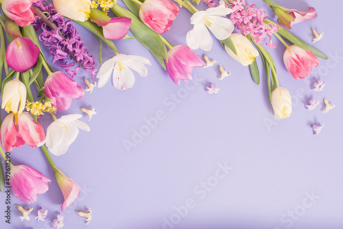 multicolored spring flowers on  purple background photo