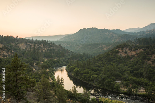 A river flows through mountains, seen from a hill
