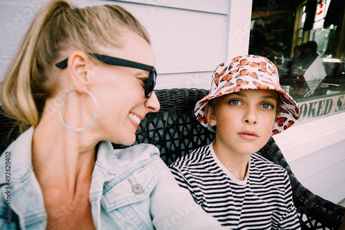 Mother and Son Sit Together on a Wicker Bench photo