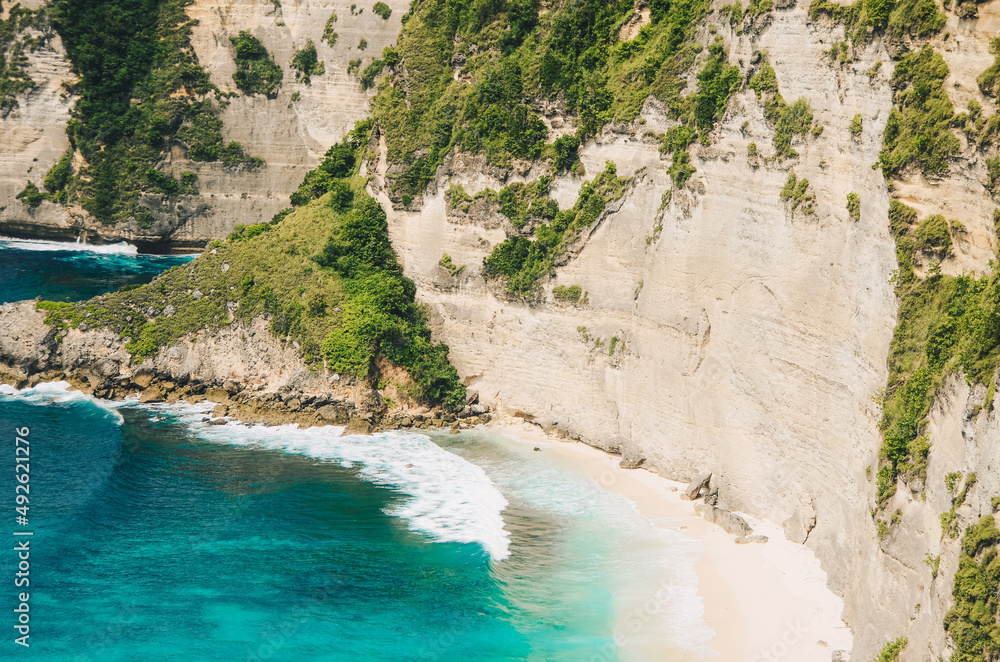 A view of the high coastline with clean and beautiful blue water, towering cliffs in front of it A view of the high coastline with clean and beautiful blue water, towering cliffs in front of it