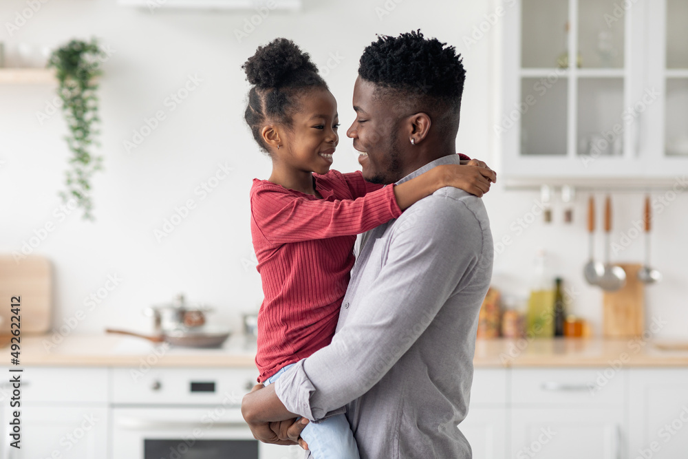 Loving black father holding his little daughter on hands Loving black father holding his little daughter on hands