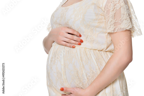 Beautiful pregnant woman posing on white background