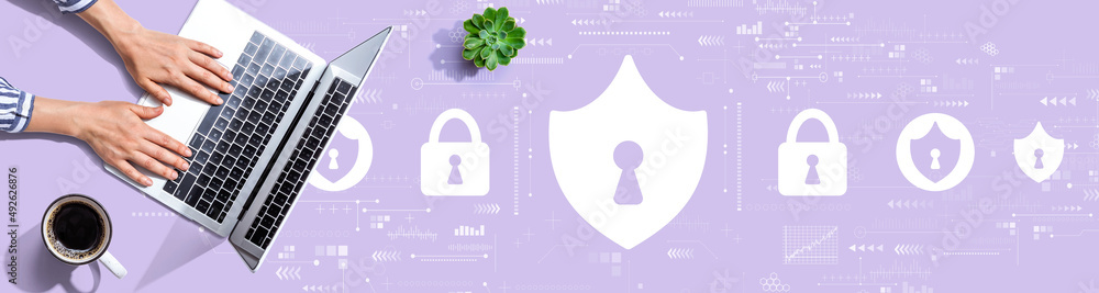 Cyber security theme with person using a laptop computer Cyber security theme with person using a laptop computer