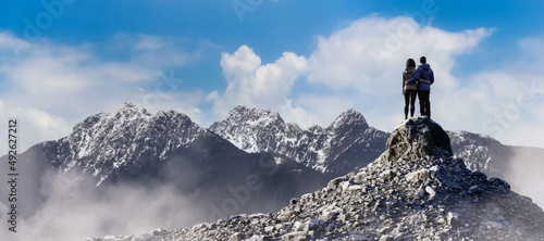 Adventure Composite of Man and Woman Couple. 3d Rendering Rocky Peak. Aerial Background Image from British Columbia, Canada. Love, Relationship Concept