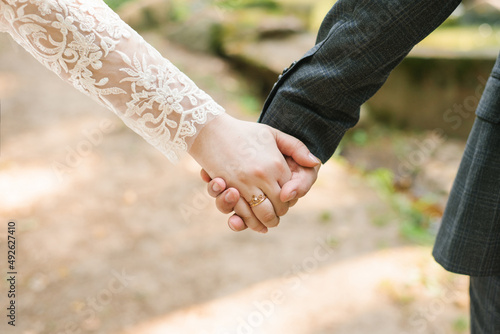Close-up of newlyweds hands with wedding rings