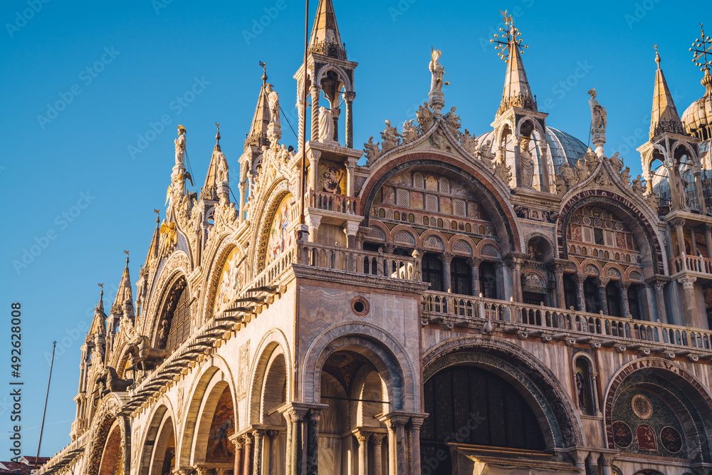 Beautiful ancient building architecture for visiting during travel excursion around Venezia city during summer touristic holidays in Italy, famous Basilica San Marco in selective focus with details