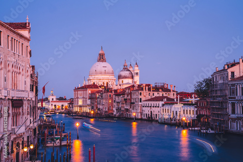 Filtred scenery landscape with lights on water of Grand Canal during evening time for romantic sightseeing in Venezia, overview of ancient architecture buildings during international vacations photo