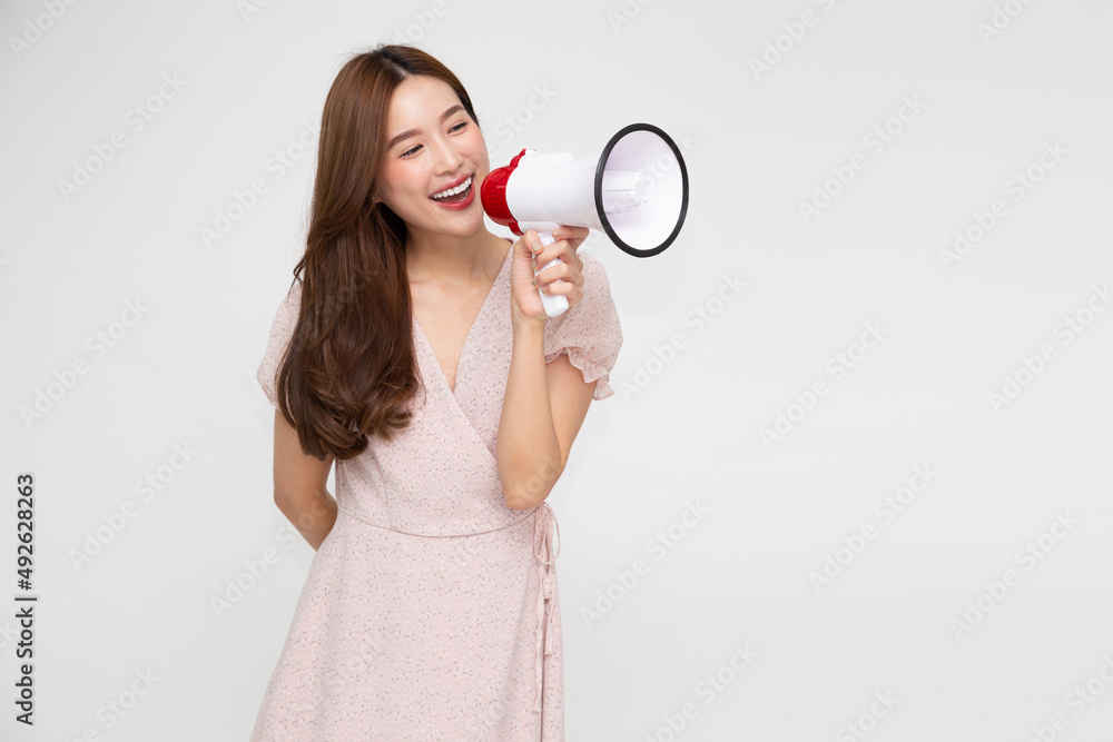 Young Asian woman holding megaphone isolated on white background, Speech and announce concept Young Asian woman holding megaphone isolated on white background, Speech and announce concept