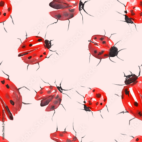 A watercolor pattern od hand paited ladybugs on a light pink background