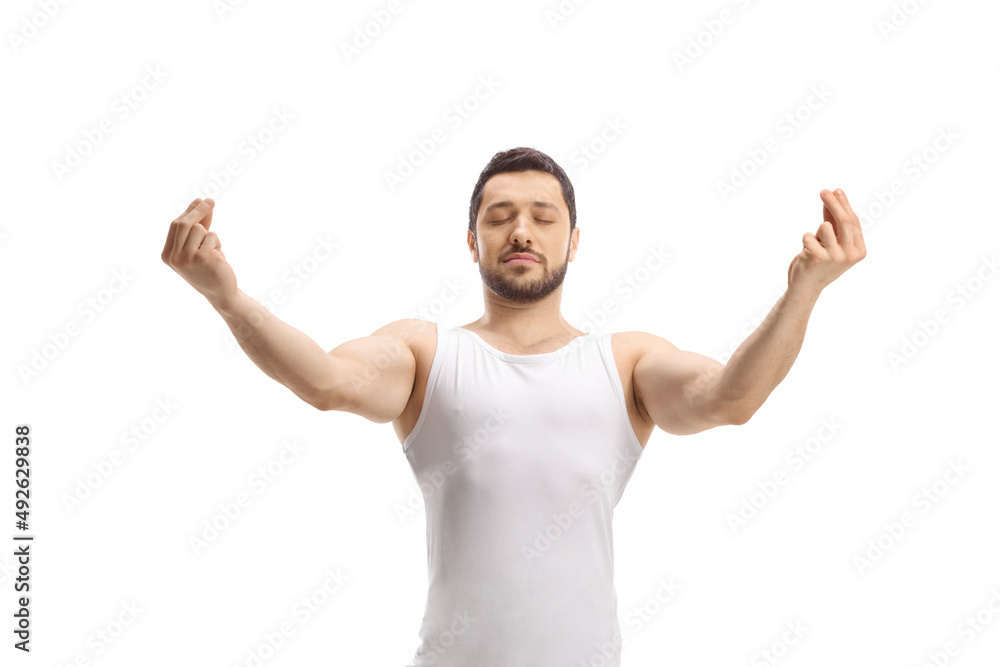 Man in a white tank top practicing a yoga pose Man in a white tank top practicing a yoga pose