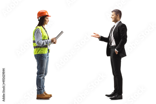 Businessman talking to a young female site engineer