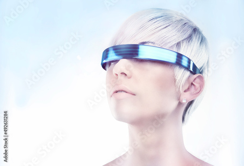 Envisioning the future. A futuristic view of a young woman with glasses.