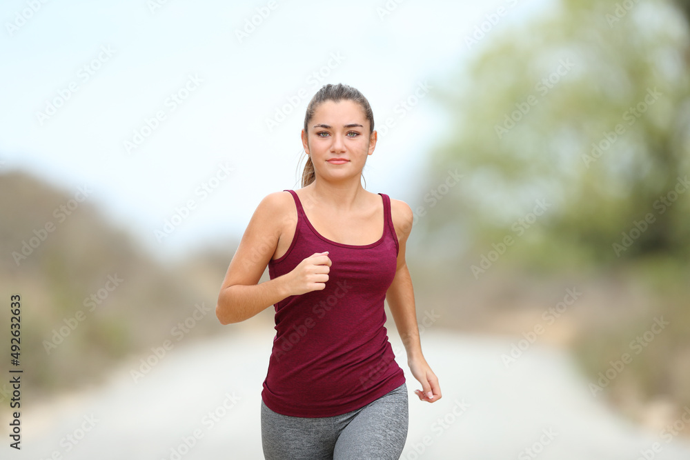 Front view of a runner jogging towards camera Front view of a runner jogging towards camera