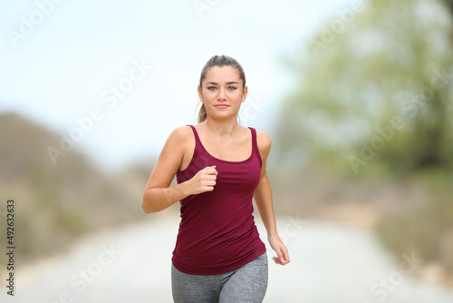 Front view of a runner jogging towards camera