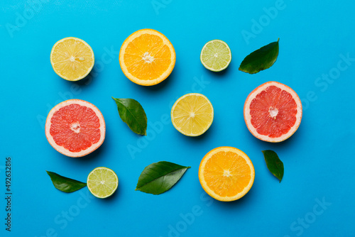 Flat lay of citrus fruits like lime  orange and lemon with lemon tree leaves on light colored background. Space for text healthy concept. Top view