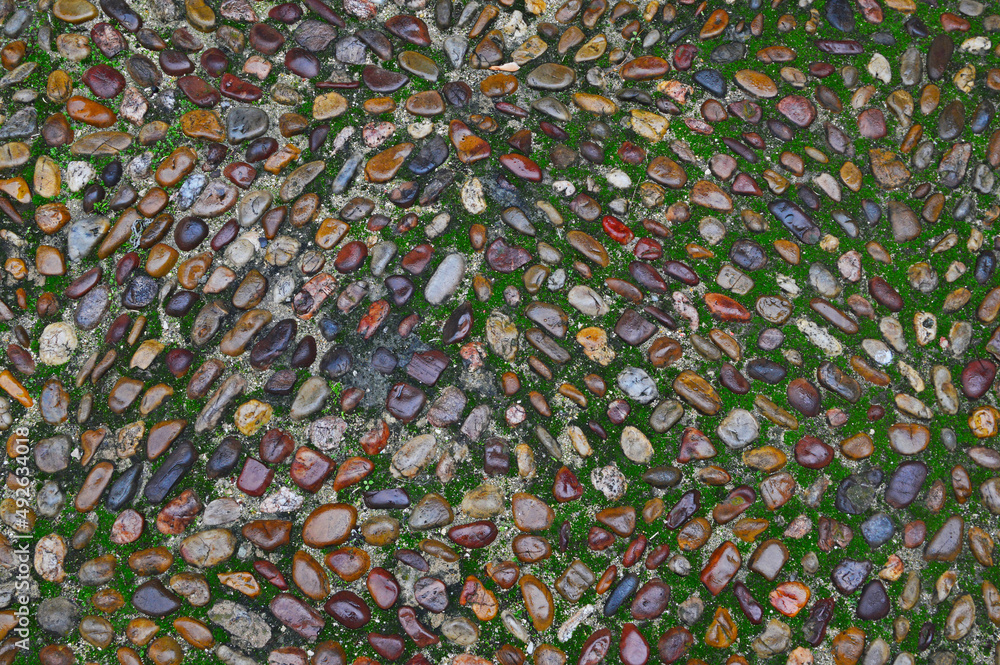 The sidewalk is lined with oval stones The sidewalk is lined with oval stones