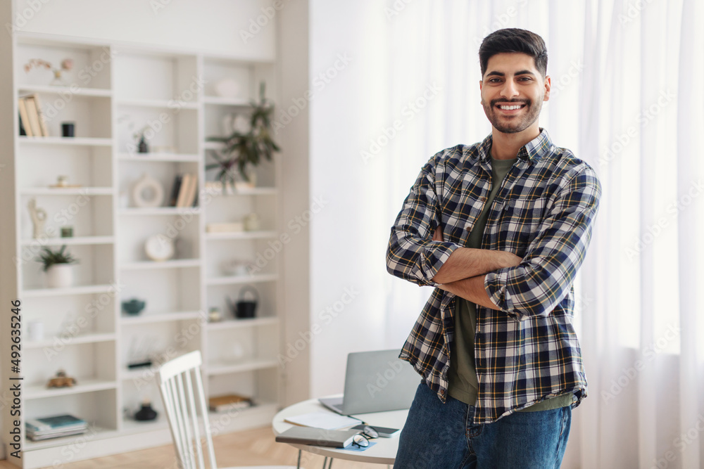 Portrait of happy man posing with folded arms Portrait of happy man posing with folded arms