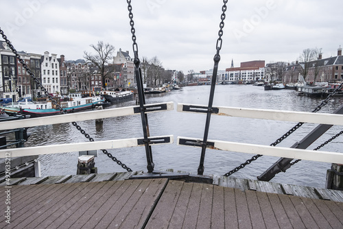 Photography One of most beautiful bridges of Amsterdam - Magere Brug (Skinny Bridge, 1871), bridge over river Amstel, popular historic site, narrow bridge for pedestrians & cyclists