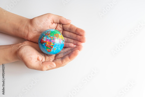 boy holding globe, globe in palm.Earth and energy concept.