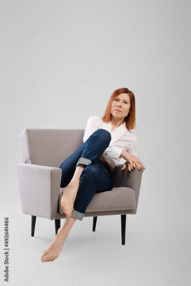 Middle age woman relax in cozy armchair Middle age woman relax in cozy armchair