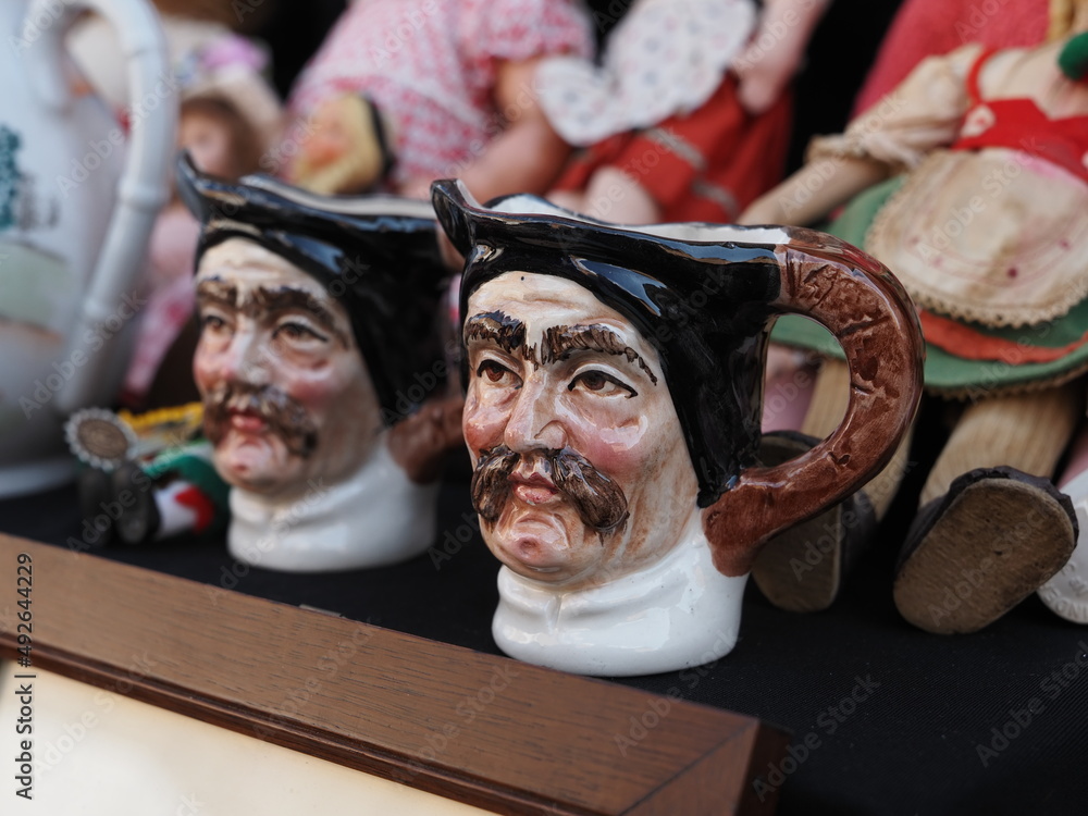 Flea market. Two vintage mugs in the shape of a mustachioed man's face.