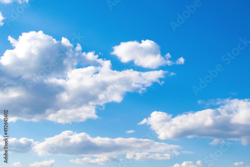 Bright scenic beautiful nature panoramic landscape of white puffy cumulus clouds floating in clear blue clear sky, skyline horizon backdrop background