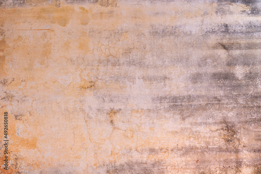 Weathered wall textured background with its color fading 