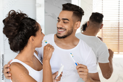 Romantic Arabic Spouses Bonding At Home While Brushing Teeth In The Morning