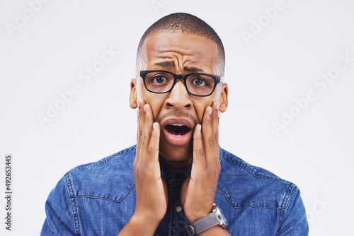 I don even have words for you. Studio portrait of a handsome young man looking shocked against a grey background.