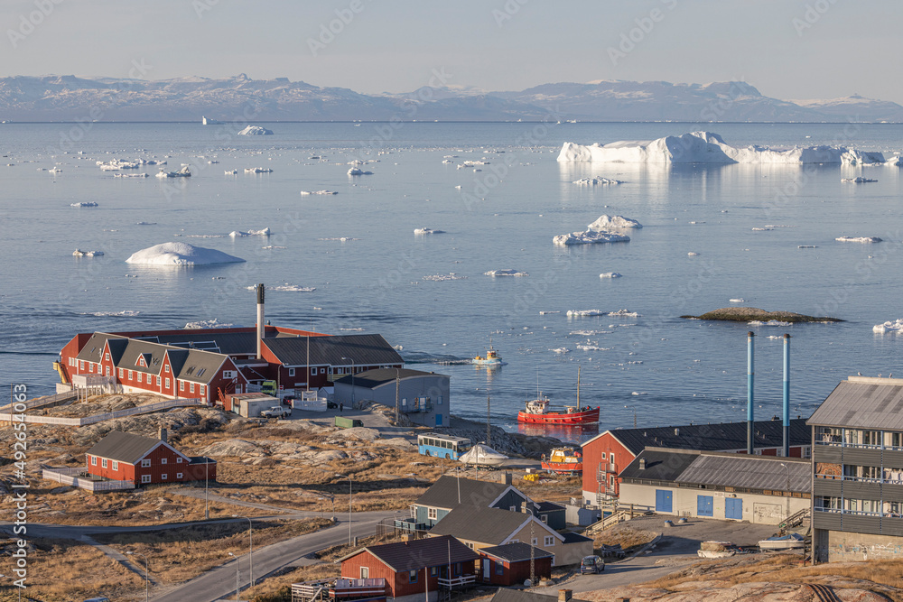 Obraz premium típico pueblo groenlandés en el círculo polar ártico rodeado de icebergs.