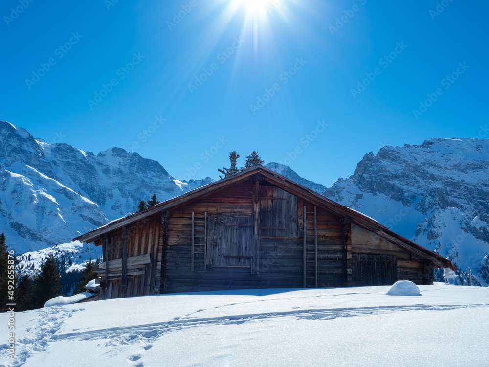 A typical Swiss mountain hut on a sunny winter day