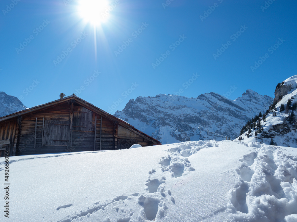 A typical Swiss mountain hut on a sunny winter day