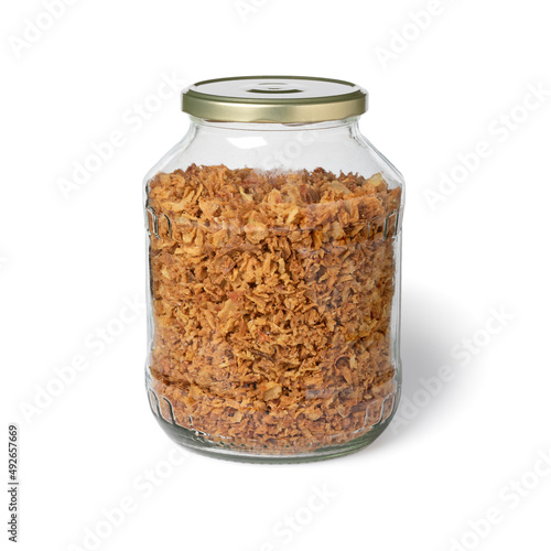 Glass jar with dried onions close up isolated on white background