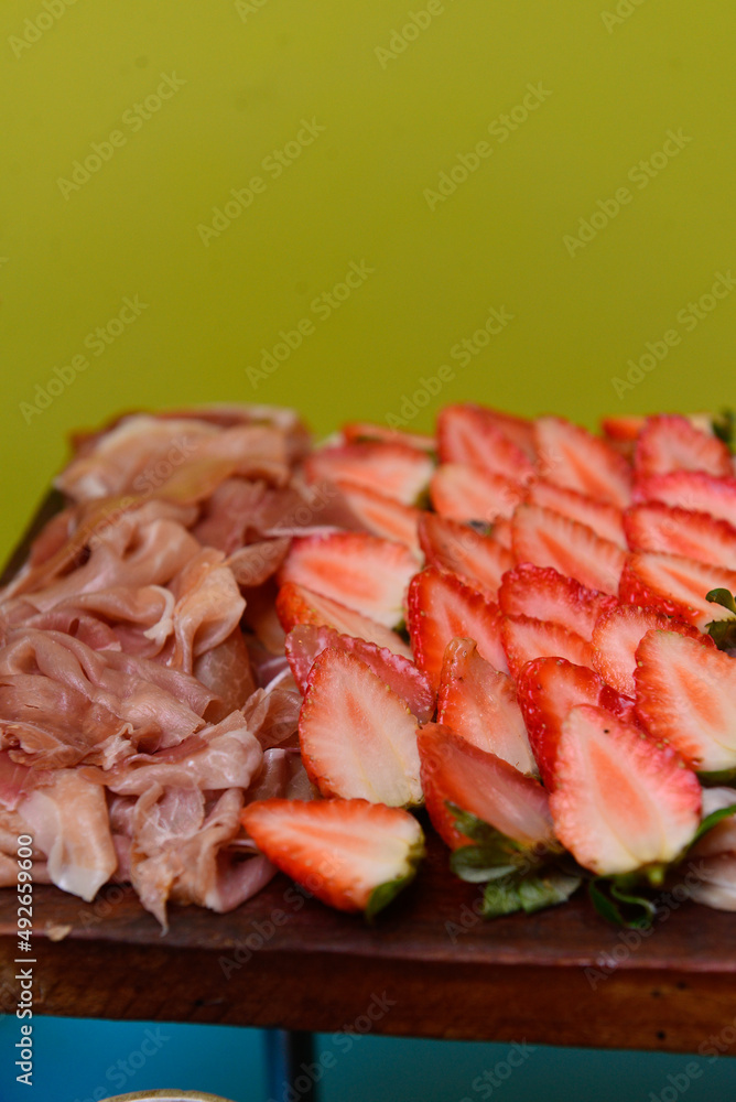close-up of slices of ham and strawberries, strawberries and parma ham