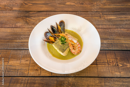 Hake in green sauce is a Basque cuisine dish whose main ingredient is hake accompanied by a green sauce and clams. It is traditionally served in a clay pot with a chopped hard-boiled egg.