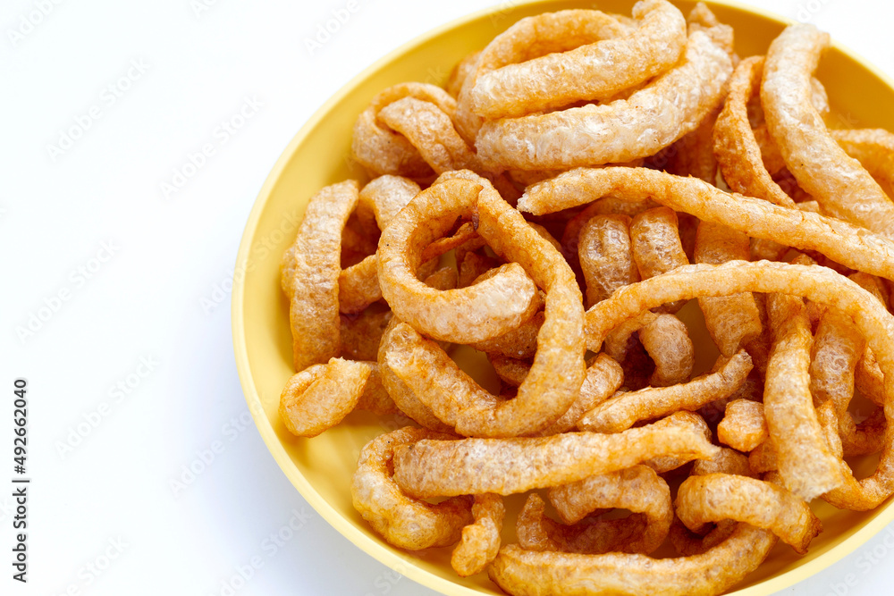 Fried crispy pork rinds on white background. Fried crispy pork rinds on white background.