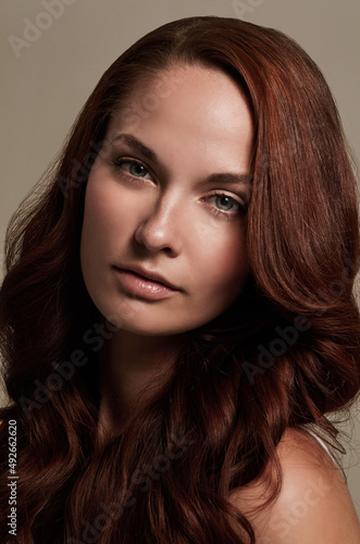 Shes a fiery beauty. Closeup portrait of an attractive young woman in studio.