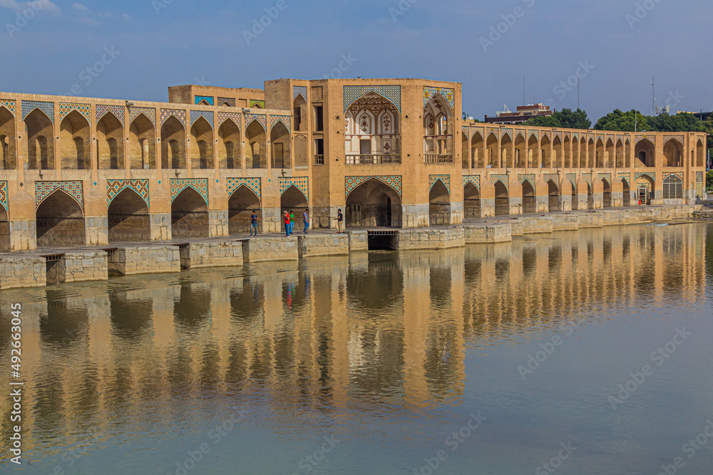 ISFAHAN, IRAN - JULY 10, 2019: People at Khaju (Khajoo) bridge in Isfahan, Iran
