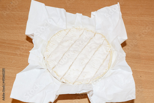 Camembert cheese in wrapping paper