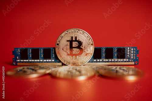 gold coins bitcoin and RAM on a red background